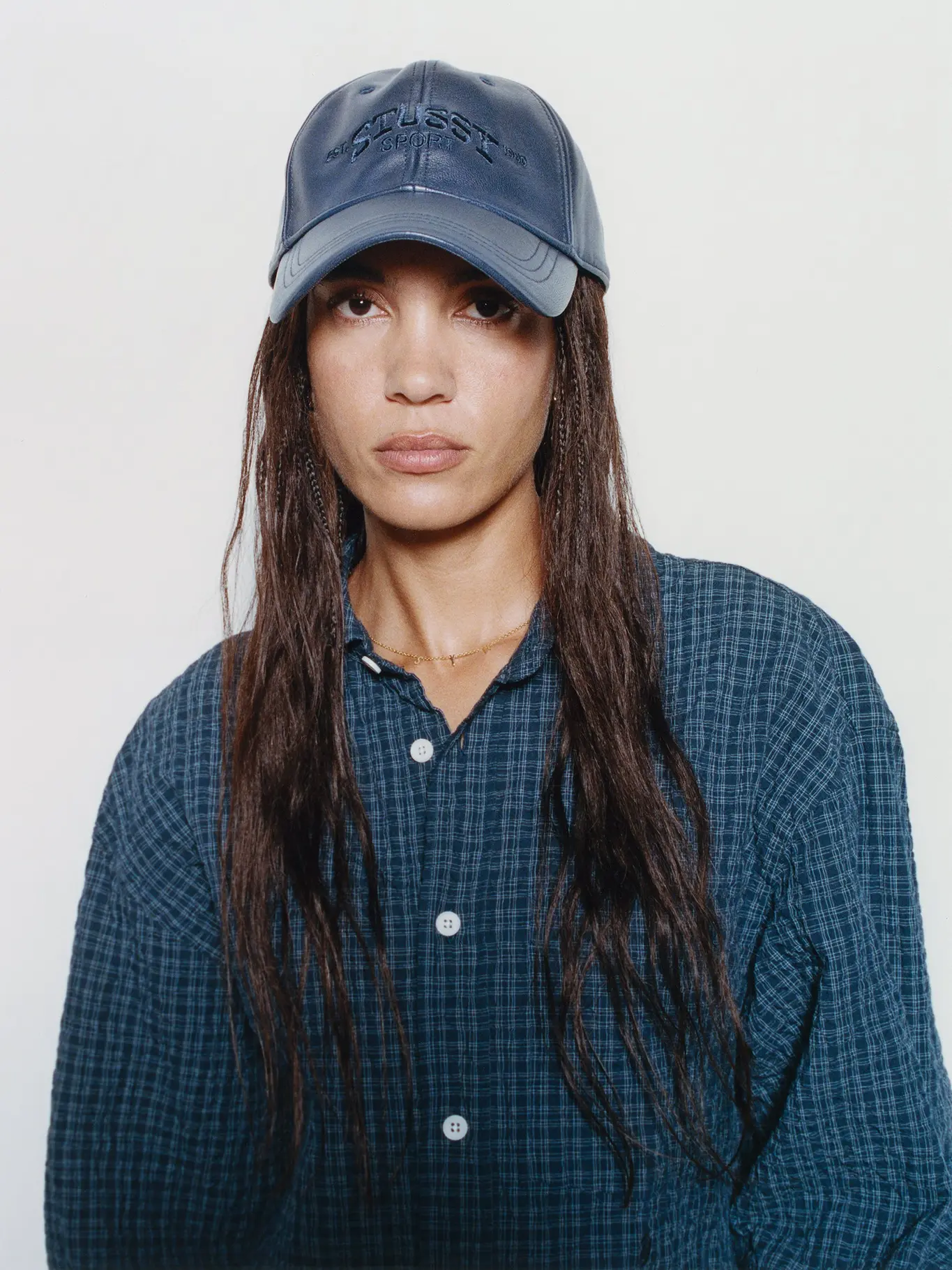 Model wearing navy technical jacket from Stussy's Fall '26 Helinox collaboration collection.